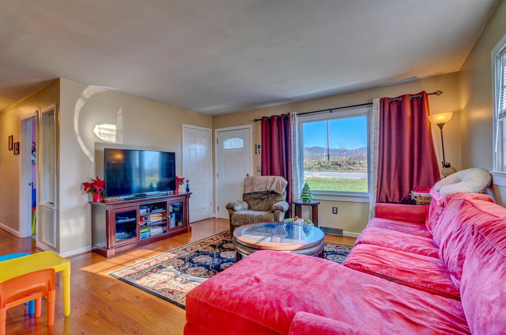 1716 Mountain View Road Vinton, VA 24179 - Photo 7 of 28 a living room with furniture windows and a flat screen tv