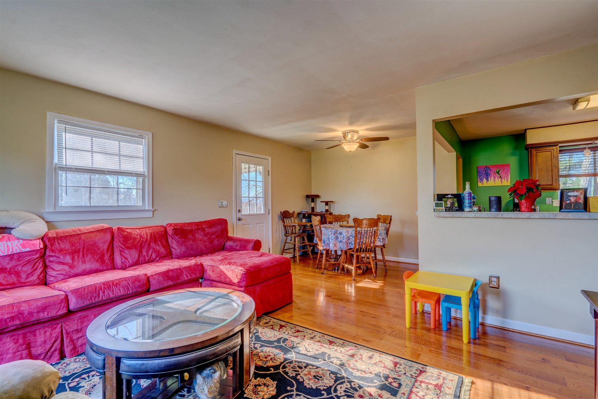 1716 Mountain View Road Vinton, VA 24179 - Photo 8 of 28 a living room with furniture and a dining table with wooden floor