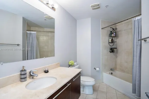 a bathroom with a sink toilet tub and shower