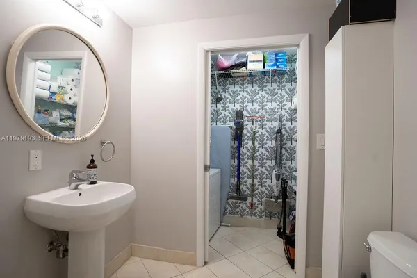 a bathroom with a sink a toilet and a mirror