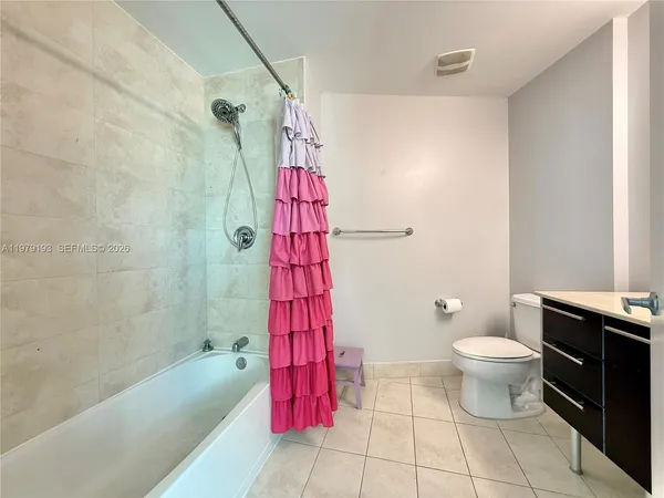 a bathroom with a toilet sink and shower