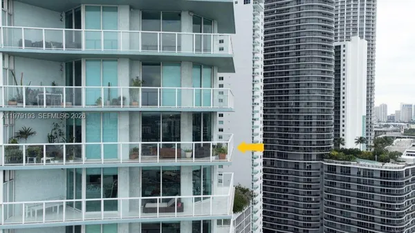 a view of balcony with a couple of white chairs