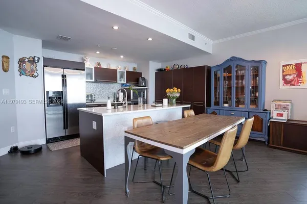 a dining table with chairs and refrigerator