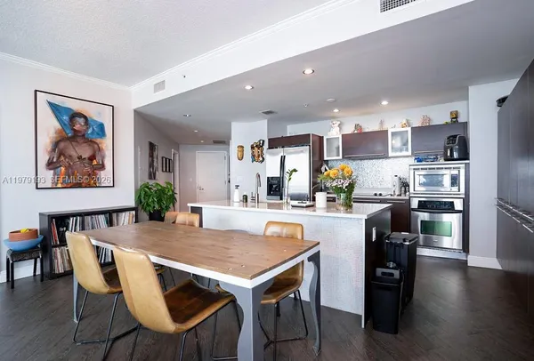 a kitchen with a table and chairs in it