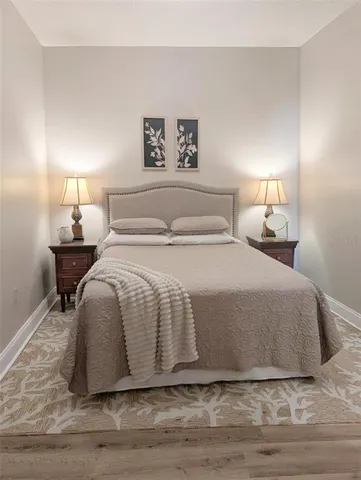 a bedroom with a bed and a lamp