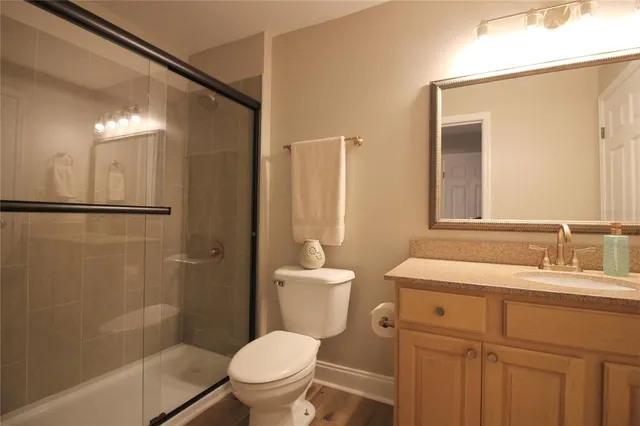 a bathroom with a sink a toilet and shower