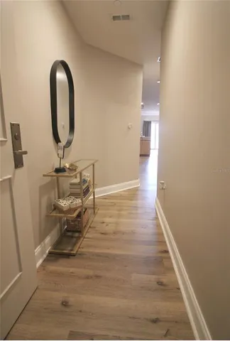 a view of a room with wooden floor and potted plant