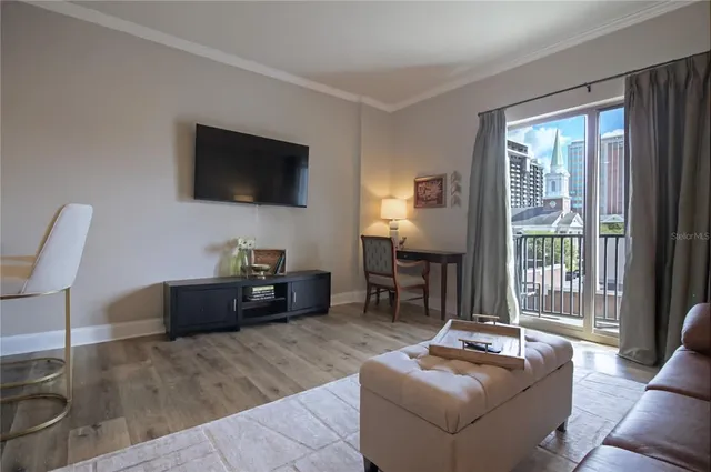 a living room with furniture and a flat screen tv