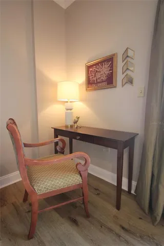 a room with a table chairs and wooden floor