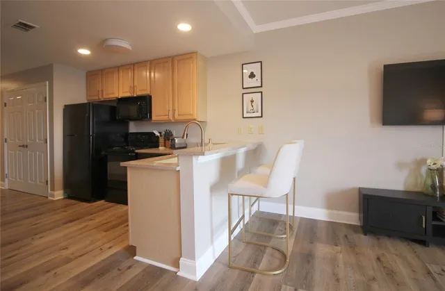 a kitchen with stainless steel appliances a refrigerator and a stove top oven