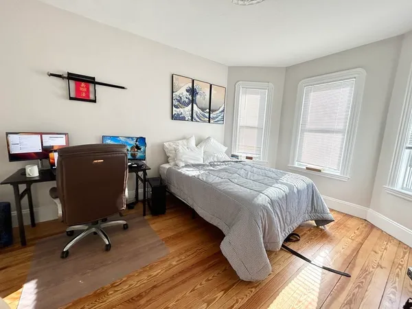 a bedroom with a bed and a desk