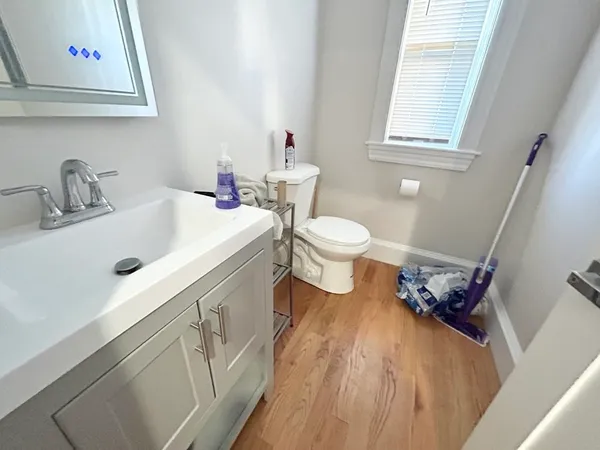a bathroom with a sink toilet and a mirror