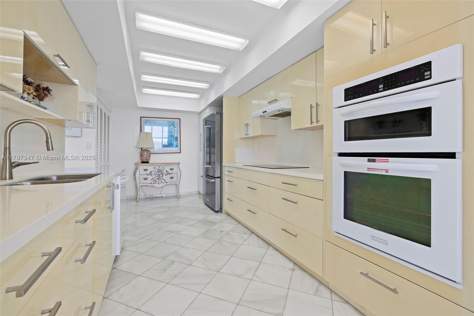 520 Brickell Key Drive, Unit A201 Miami, FL 33131 - Photo 12 of 52 a kitchen with stainless steel appliances a stove microwave and cabinets