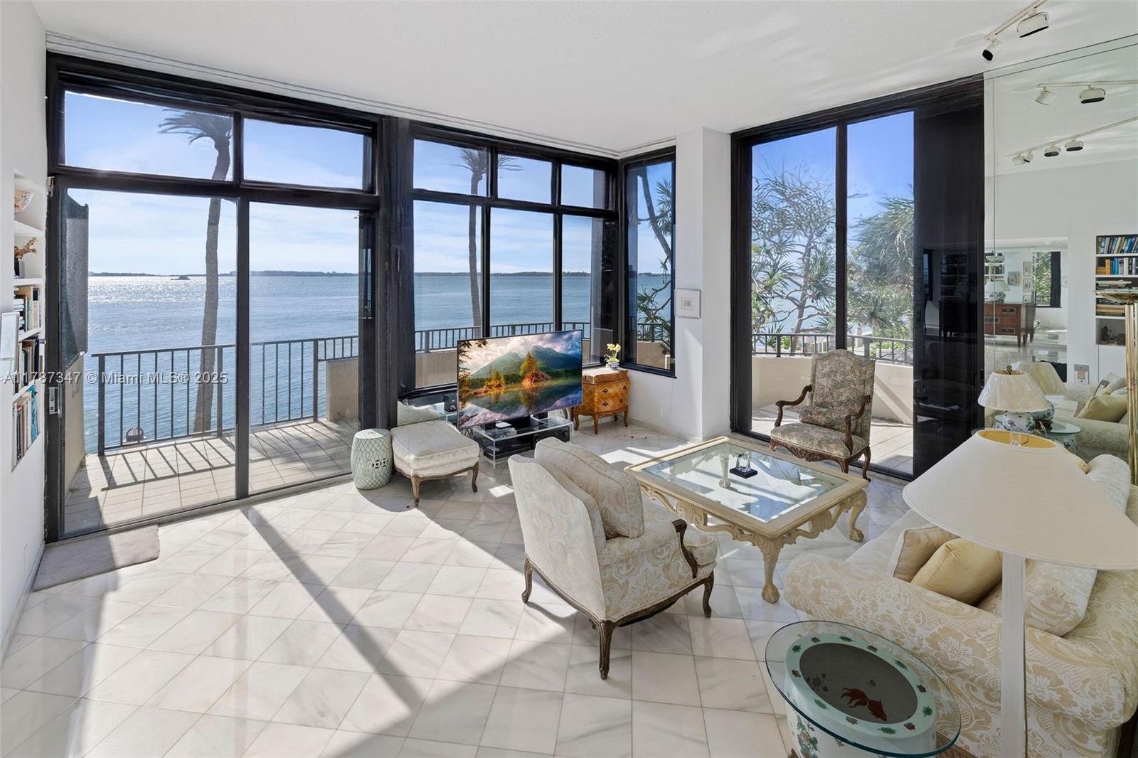 520 Brickell Key Drive, Unit A201 Miami, FL 33131 - Photo 19 of 52 a living room with furniture and floor to ceiling windows