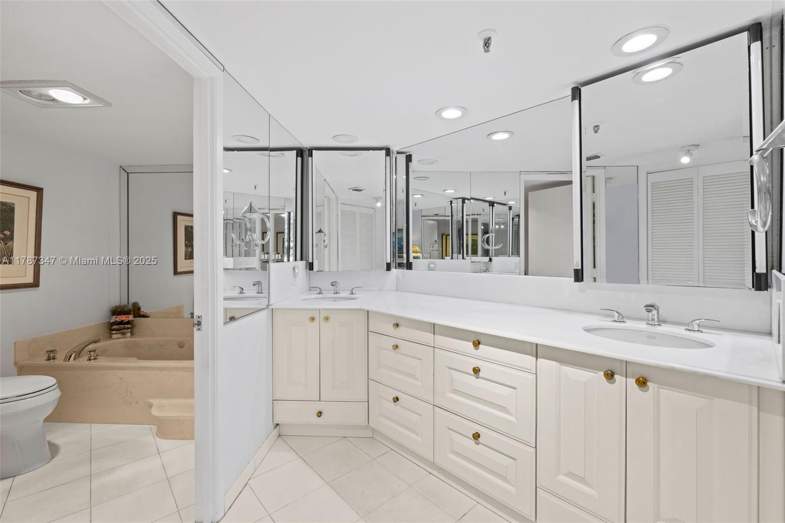 520 Brickell Key Drive, Unit A201 Miami, FL 33131 - Photo 23 of 52 a spacious bathroom with a granite countertop sink a toilet a mirror and shower