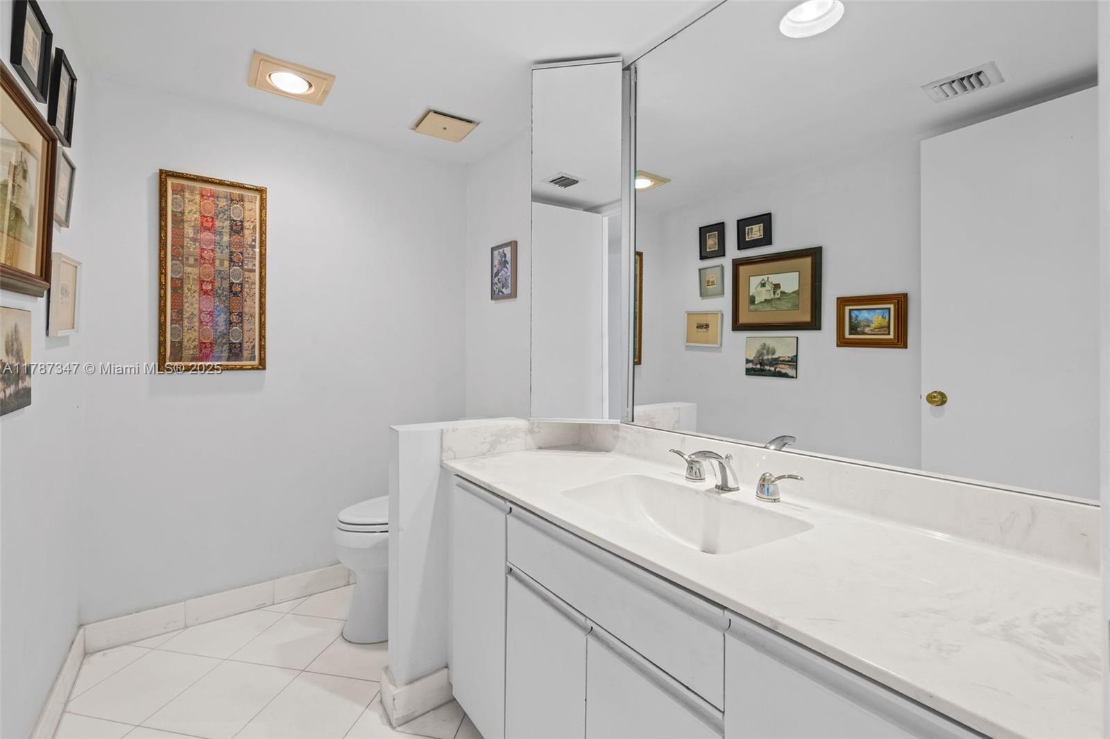 520 Brickell Key Drive, Unit A201 Miami, FL 33131 - Photo 26 of 52 a bathroom with a sink toilet and a mirror