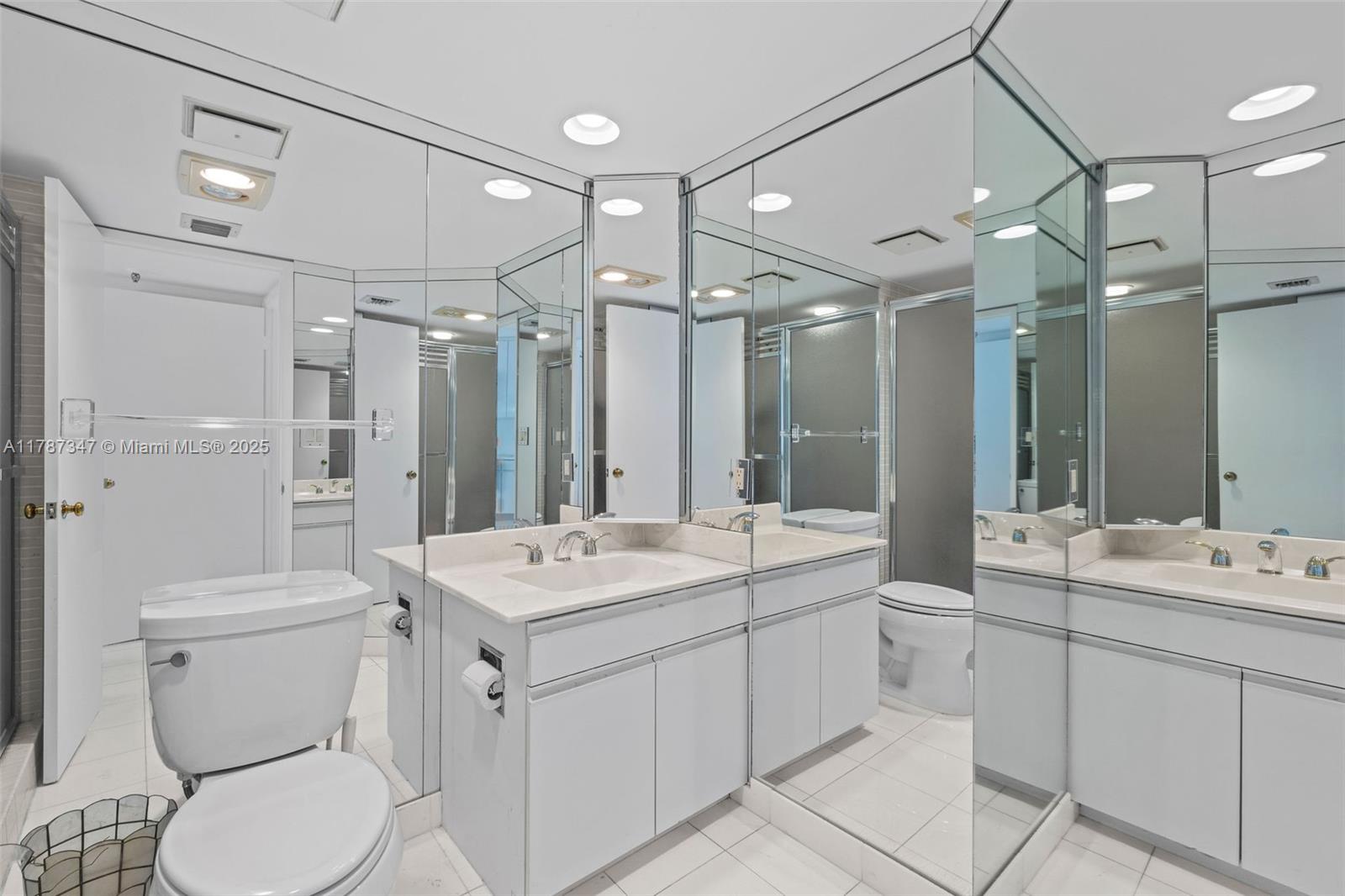 520 Brickell Key Drive, Unit A201 Miami, FL 33131 - Photo 29 of 52 a bathroom with a sink a toilet a mirror and shower