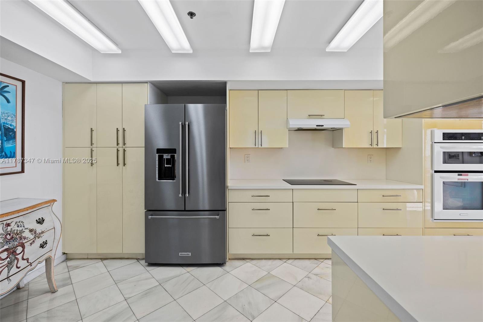 520 Brickell Key Drive, Unit A201 Miami, FL 33131 - Photo 8 of 52 a kitchen with white cabinets and stainless steel appliances