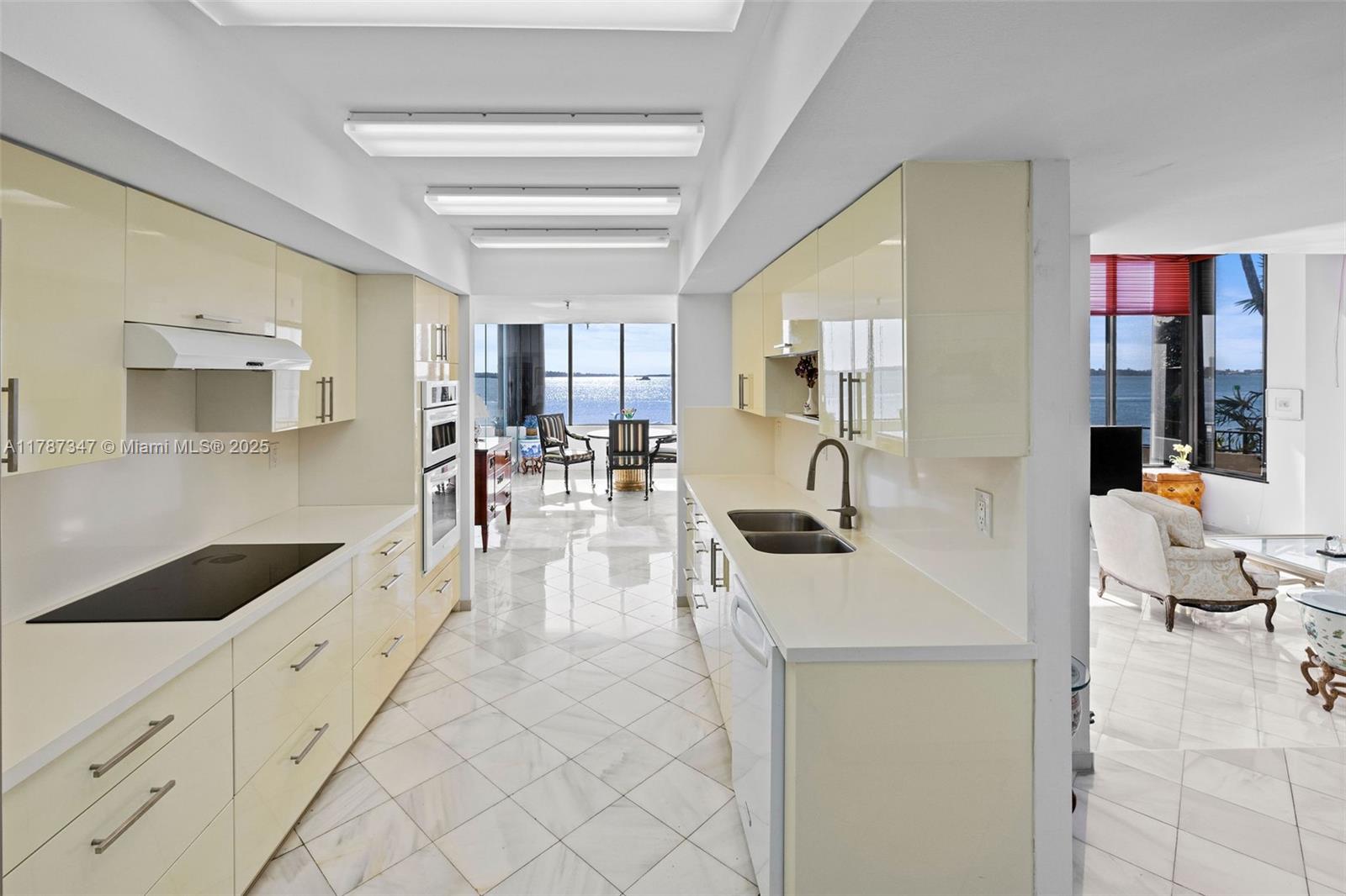 520 Brickell Key Drive, Unit A201 Miami, FL 33131 - Photo 9 of 52 a view of a kitchen with kitchen island a sink stainless steel appliances and cabinets