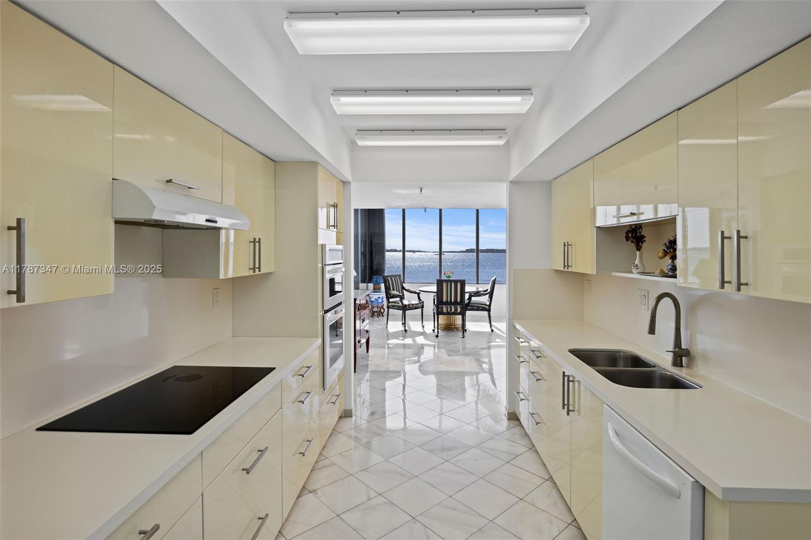 520 Brickell Key Drive, Unit A201 Miami, FL 33131 - Photo 10 of 52 a kitchen with counter top space a sink and cabinets