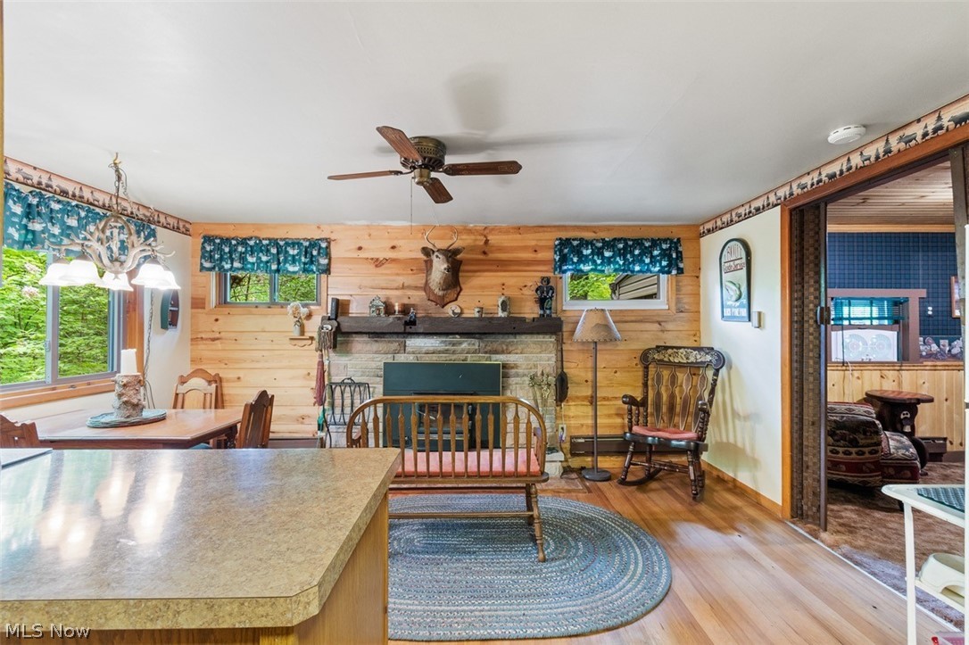 6120 Azalea Road Southwest Bowerston, OH 44695 - Photo 18 of 38 Kitchen with a stone fireplace, ceiling fan, and light hardwood / wood-style floors