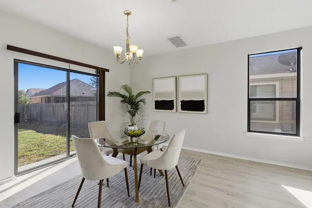 a view of a dining room with furniture window and wooden floor