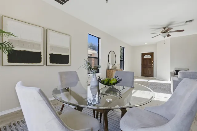 a dining room with furniture and wooden floor