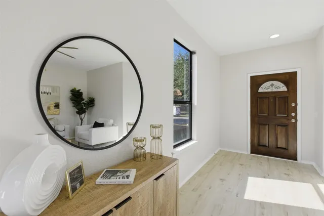 a view of a livingroom with furniture and mirror