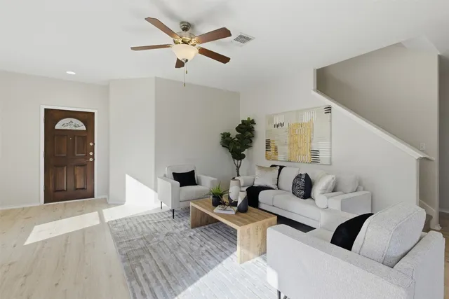 a living room with furniture and a rug