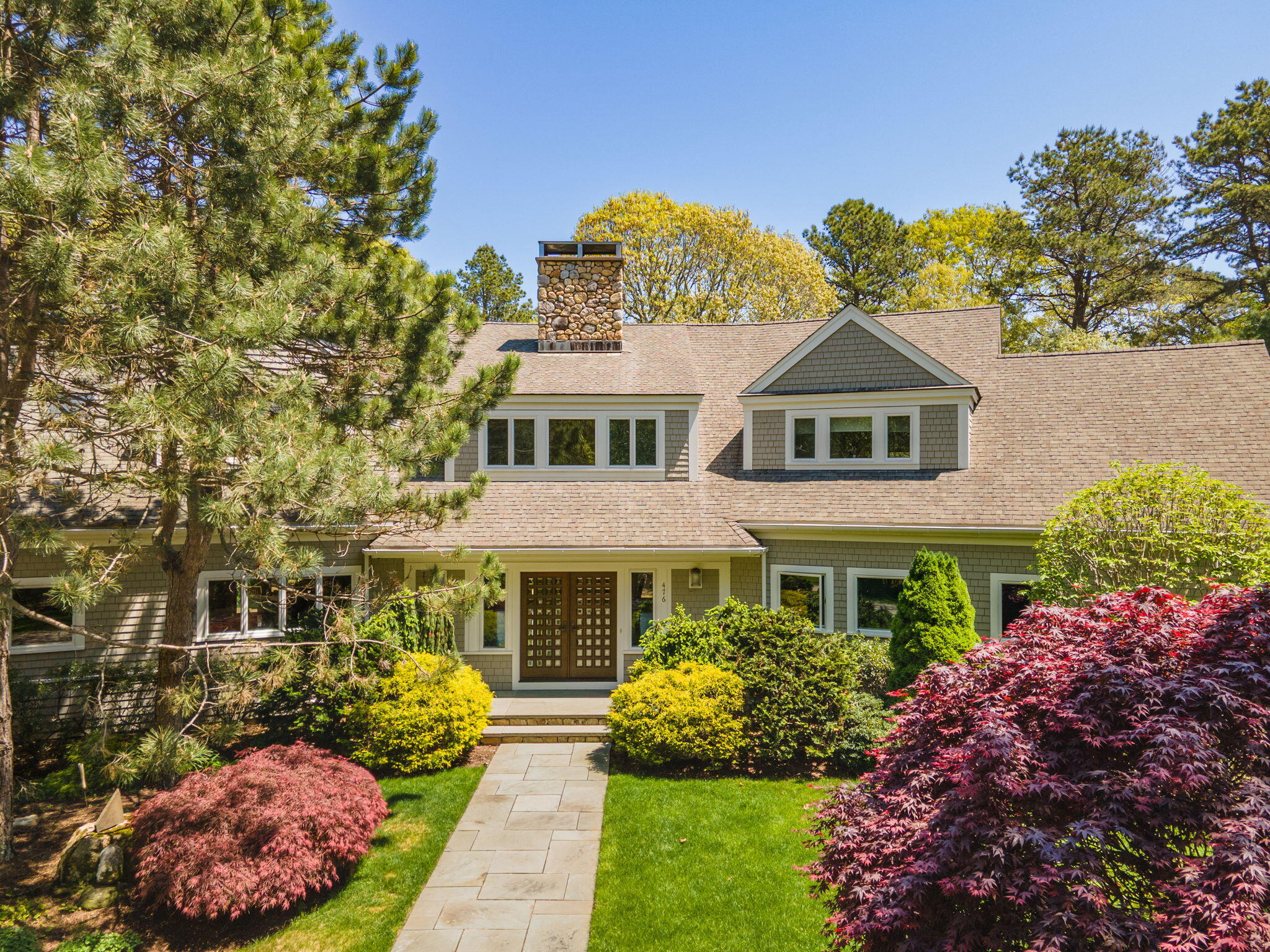 476 Baxter Neck Road Marstons Mills, MA 02648 - Photo 84 of 95 a front view of a house with a yard and potted plants