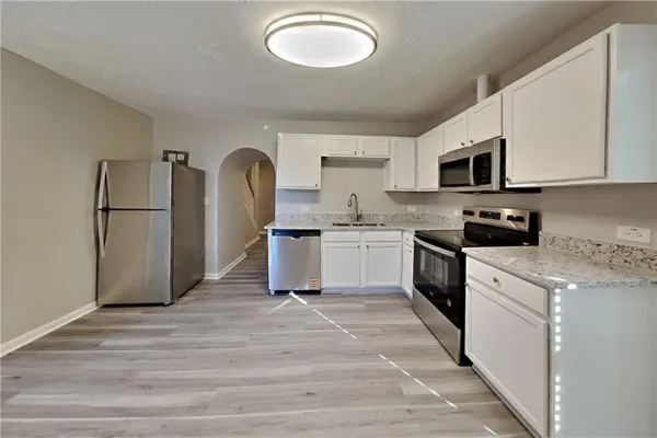 a kitchen with a sink cabinets and appliances