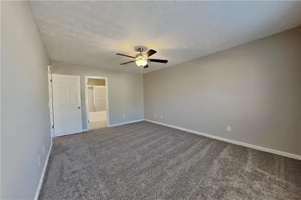 a view of an empty room with a ceiling fan