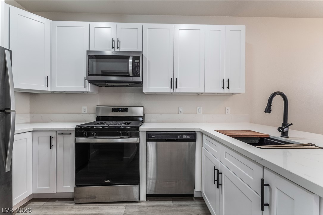 4730 East Craig Road, Unit 1058 Las Vegas, NV 89115 - Photo 11 of 30 Modern kitchen with white shaker cabinets and a complete suite of stainless steel appliances.