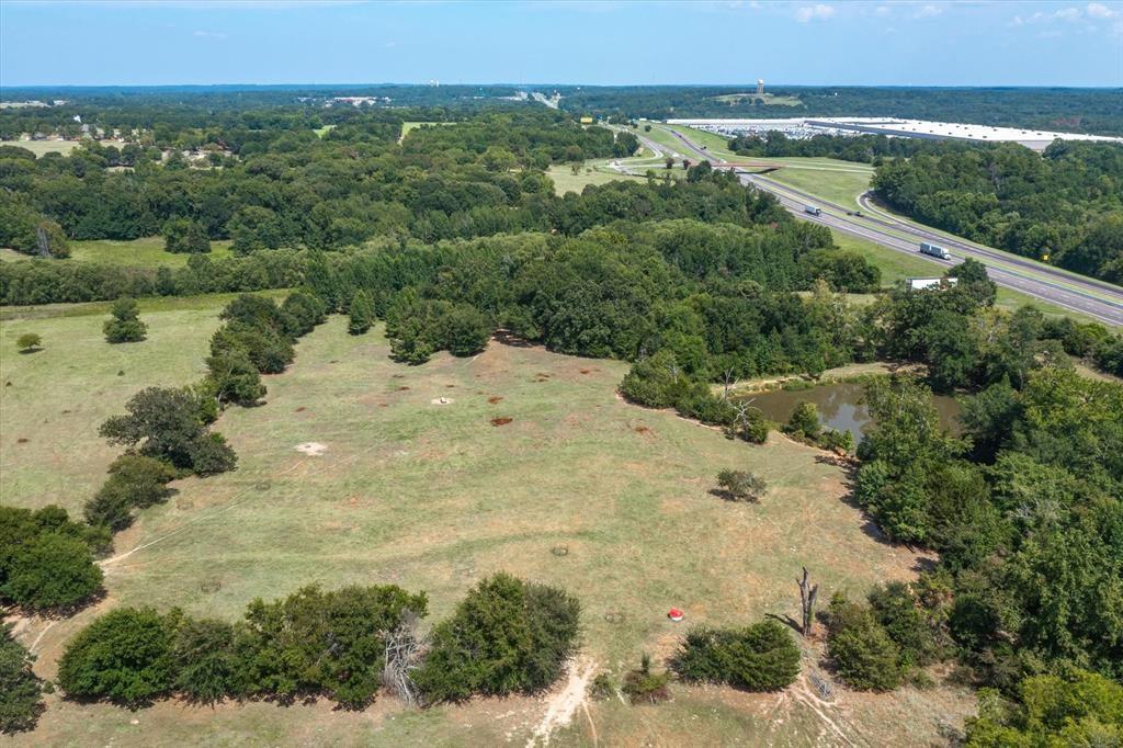 20 Interstate 20 Lindale, TX 75706 - Photo 7 of 22 a view of a lake with a mountain and trees