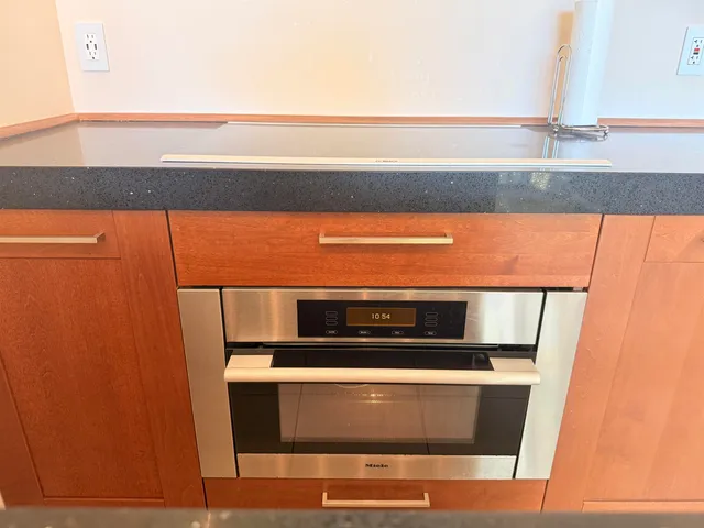 a stove top oven sitting inside of a kitchen