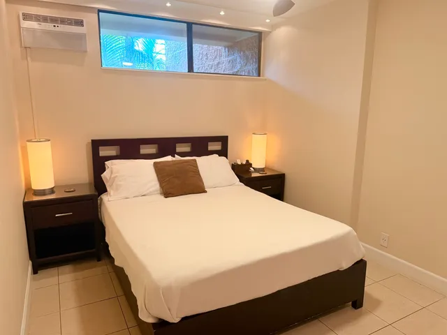 a bedroom with a bed and a night stand