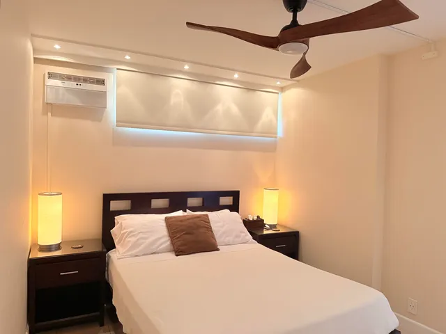 a living room with a flat screen tv and dresser