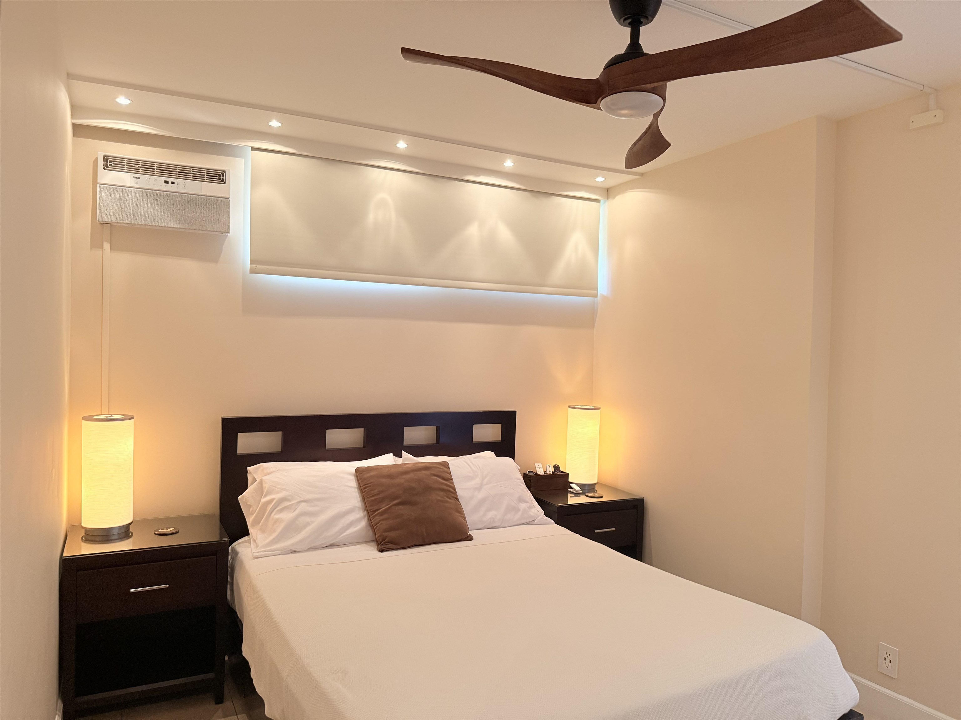 3959 Lower Honoapiilani Road, Unit 503 Lahaina, HI 96761 - Photo 15 of 47 a bedroom with a bed and a night stand