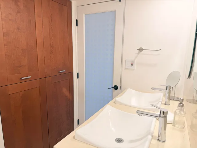 a white toilet sitting next to a shower