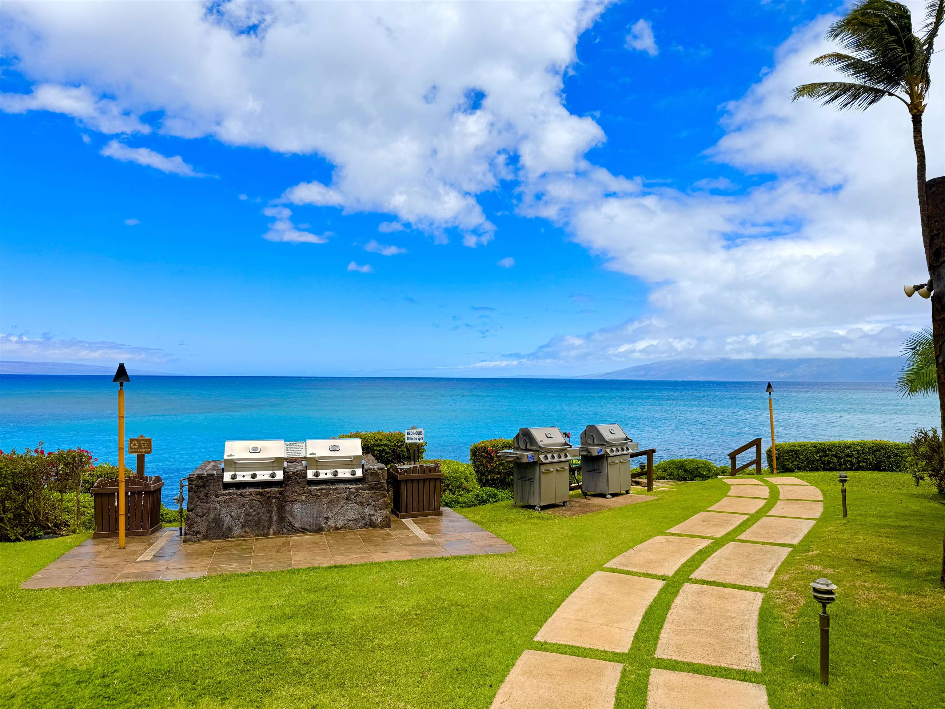 3959 Lower Honoapiilani Road, Unit 503 Lahaina, HI 96761 - Photo 30 of 47 a view of a backyard with lawn chairs
