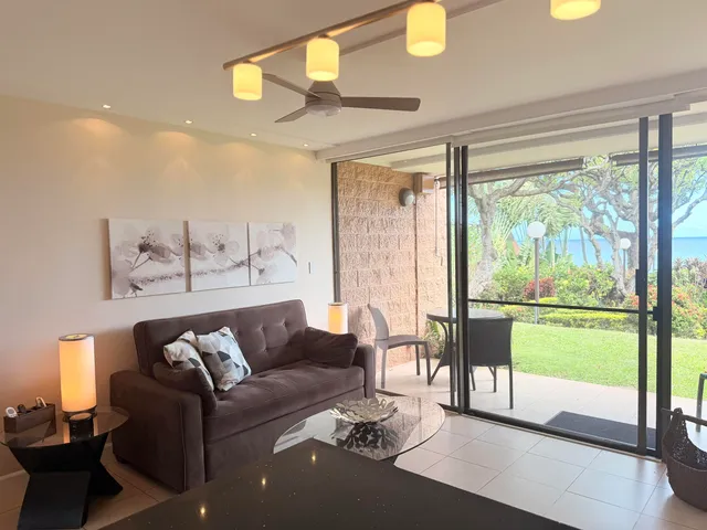 a living room with furniture and a floor to ceiling window