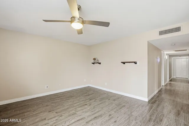 a view of a room with wooden floor