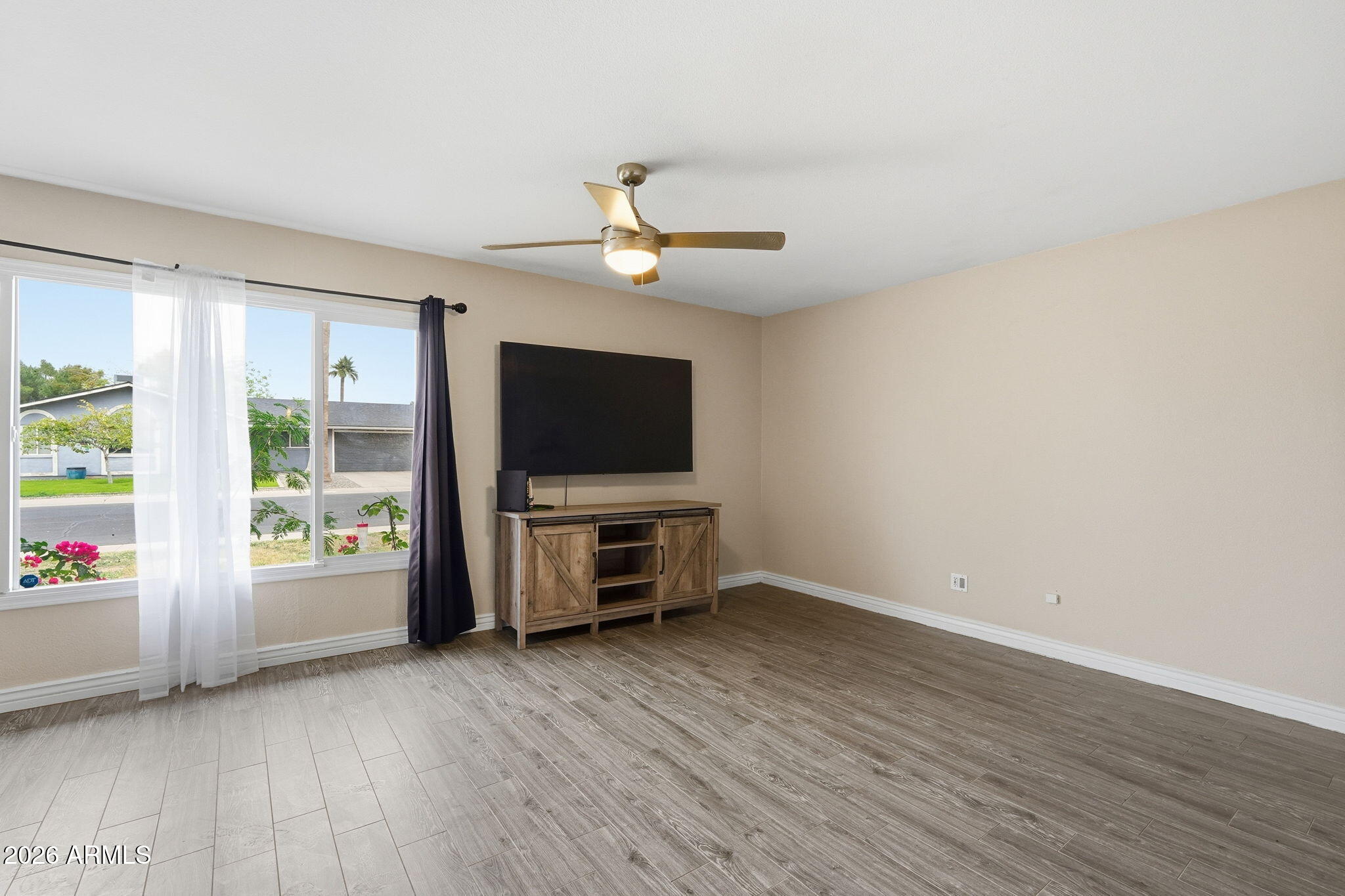 4526 South Terrace Road Tempe, AZ 85282 - Photo 15 of 30 an empty room with windows flat screen tv and windows