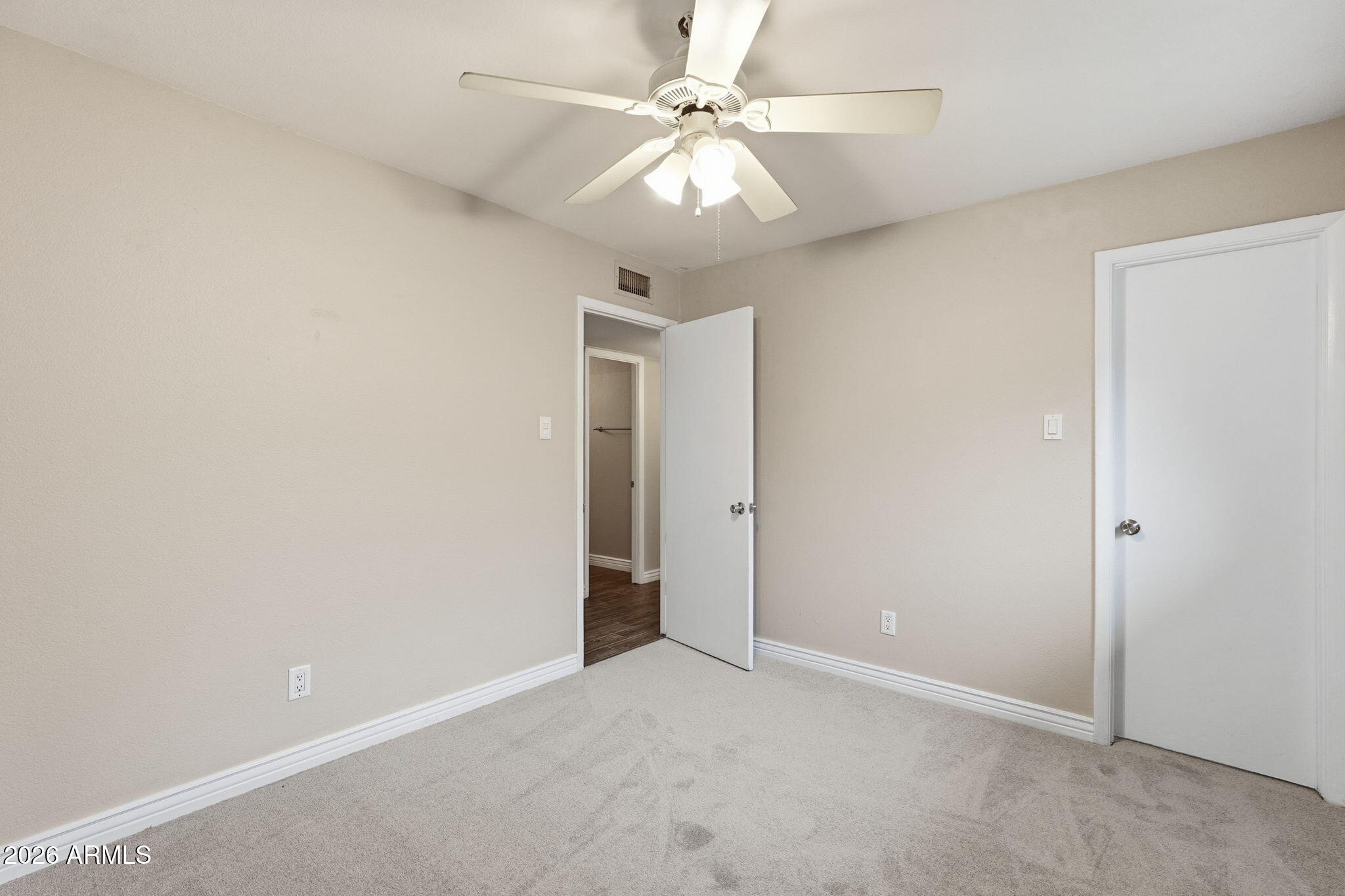 4526 South Terrace Road Tempe, AZ 85282 - Photo 19 of 30 an empty room with a chandelier fan and windows