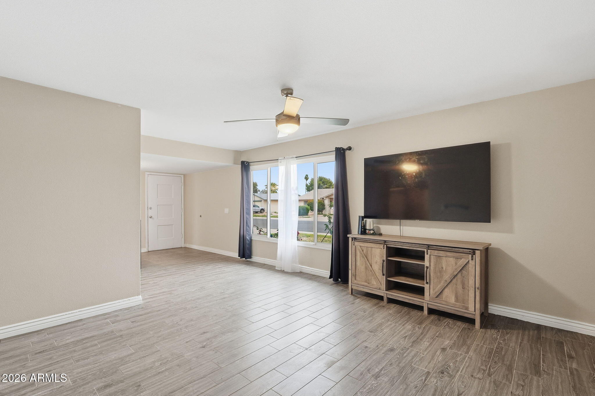 4526 South Terrace Road Tempe, AZ 85282 - Photo 4 of 30 a living room with furniture and a flat screen tv