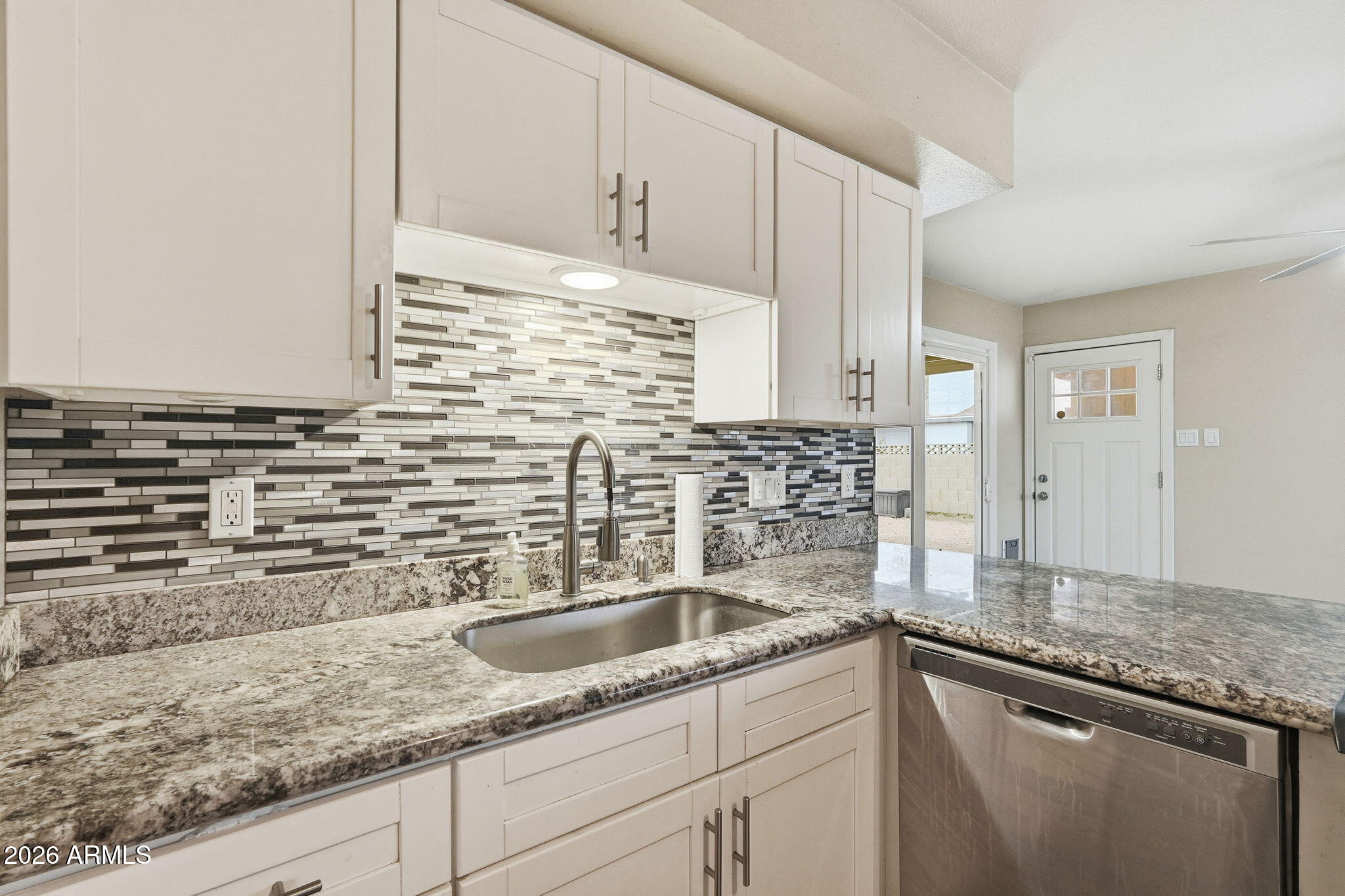 4526 South Terrace Road Tempe, AZ 85282 - Photo 5 of 30 a kitchen with stainless steel appliances granite countertop a sink and a white cabinets