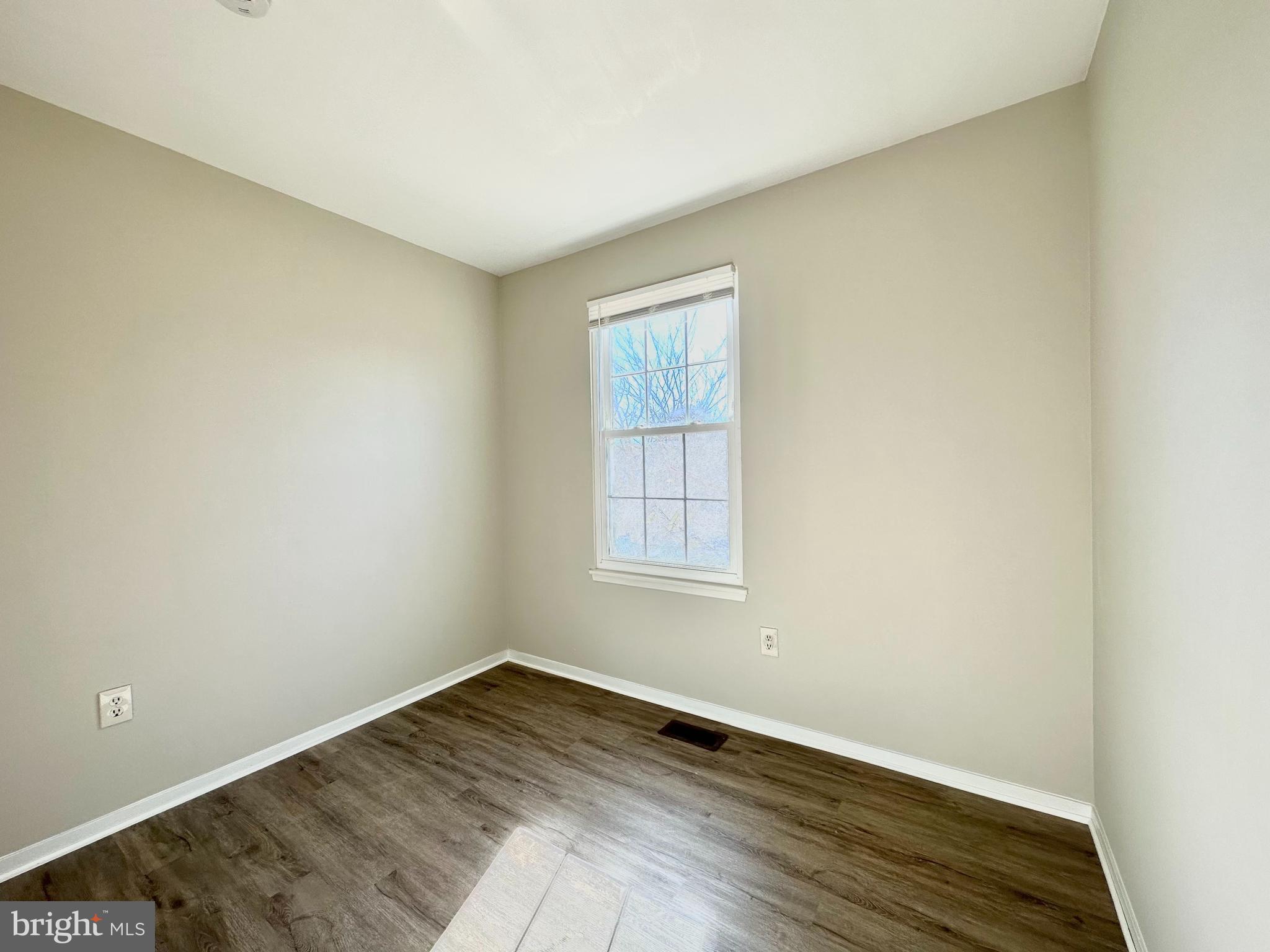 402 Carousel Court Gaithersburg, MD 20877 - Photo 23 of 29 an empty room with wooden floor and windows