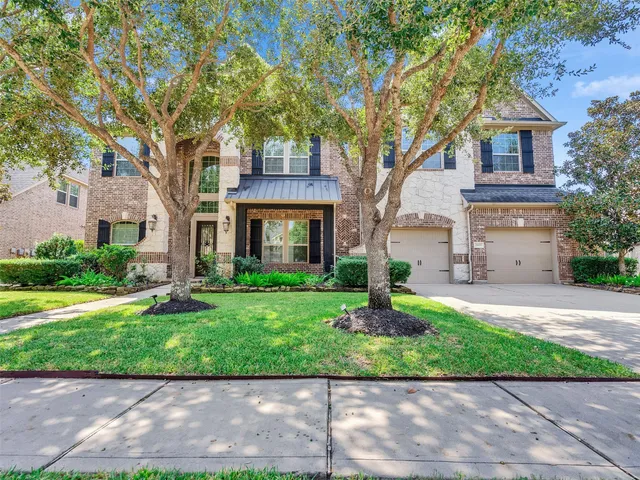 a front view of a house with a yard and a garage