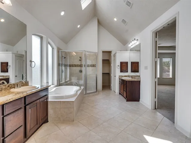 a bedroom with a large bed and a large window