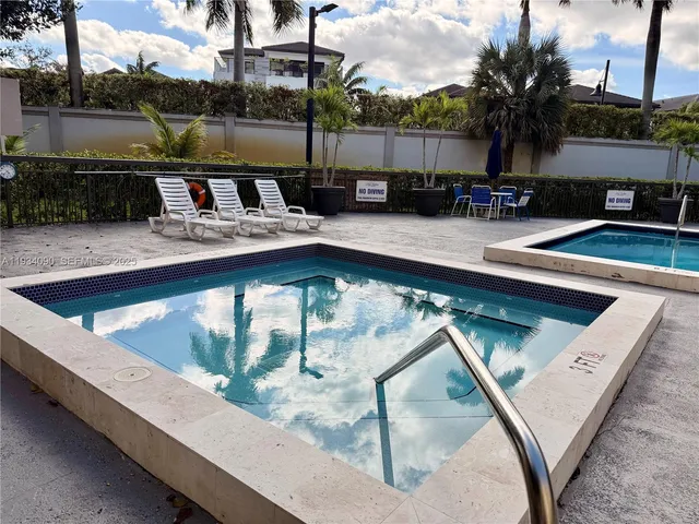 a view of swimming pool with outdoor seating and lake view